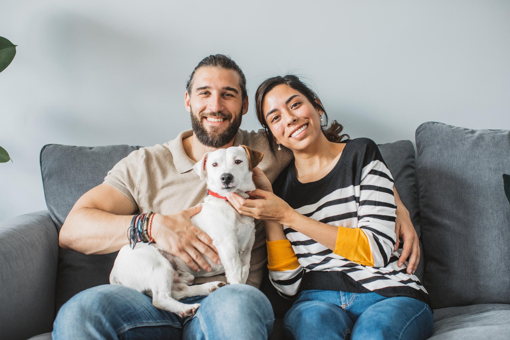 Couple and dog relaxing on couch