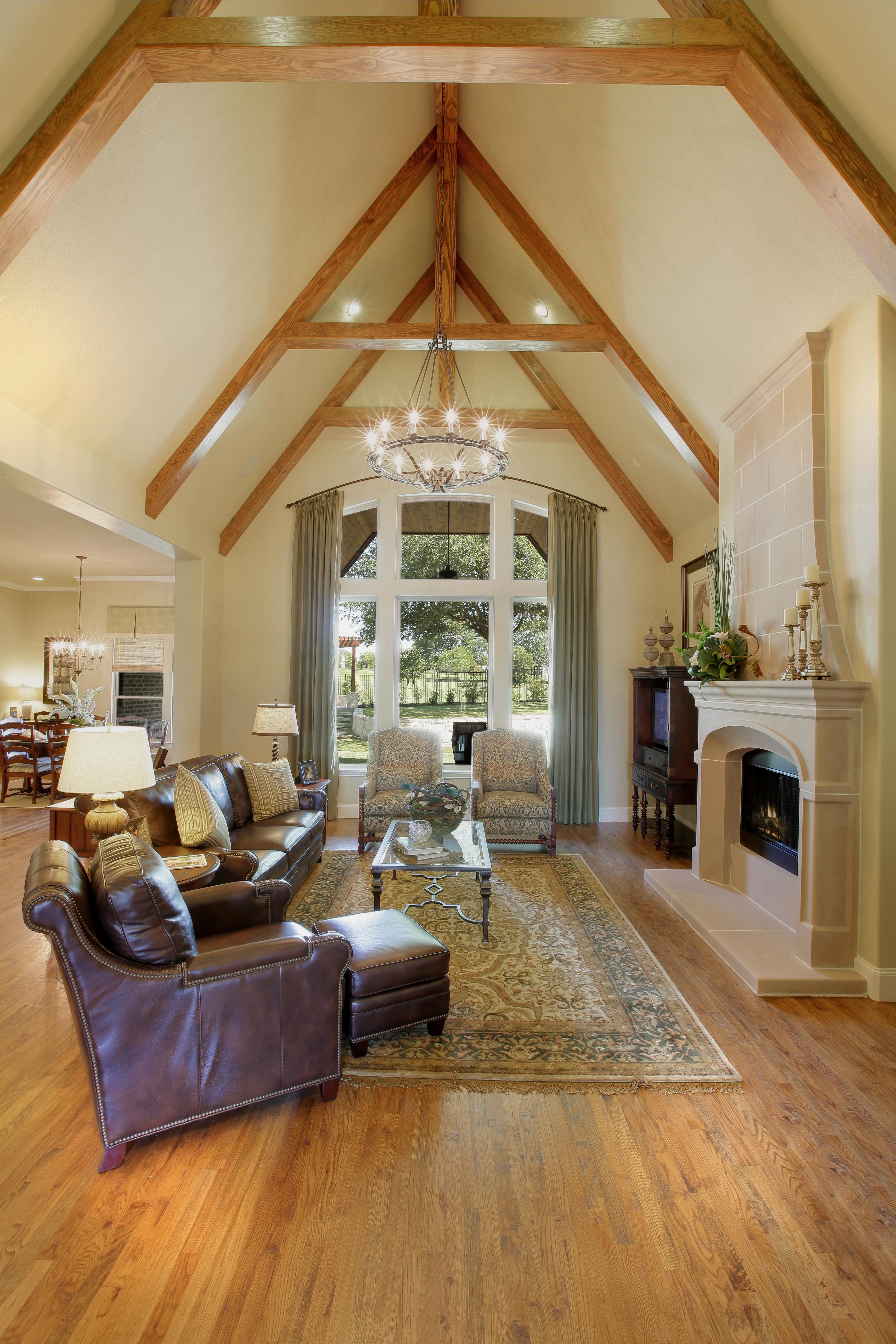 Family room with beam ceilings, hardwood floors and ceramic tile fireplace