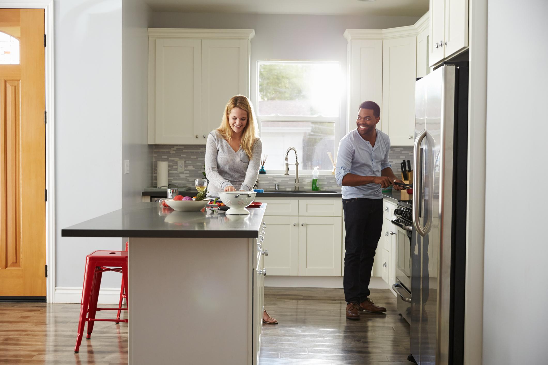 Couple cooking together in kitchen