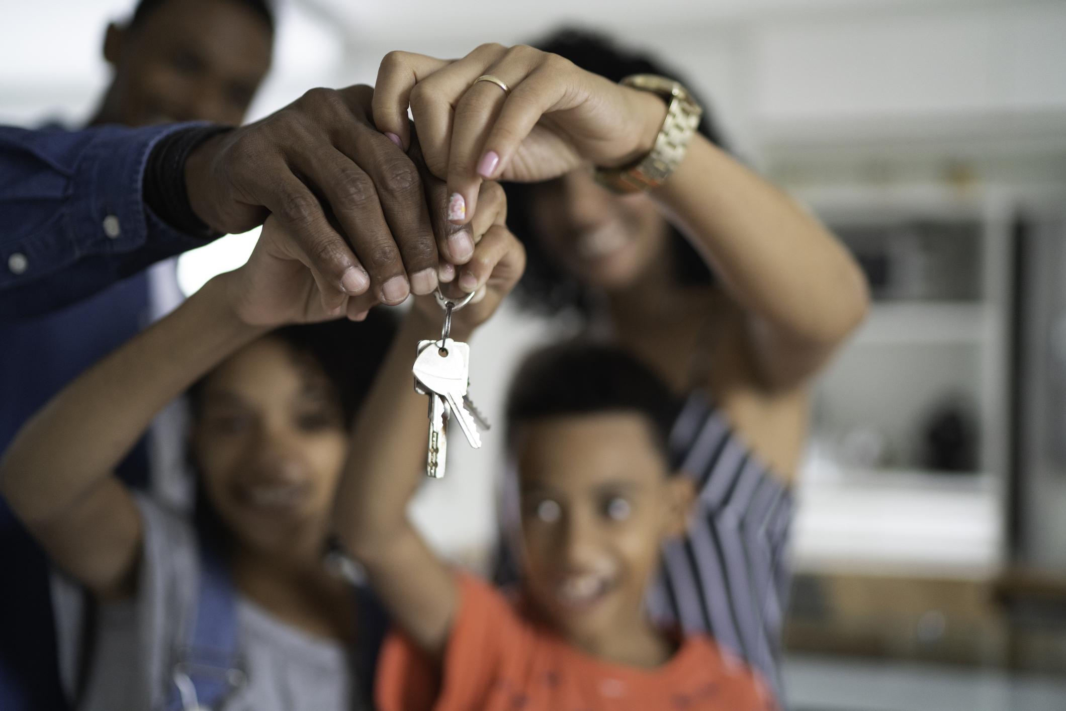 Family holding house keys