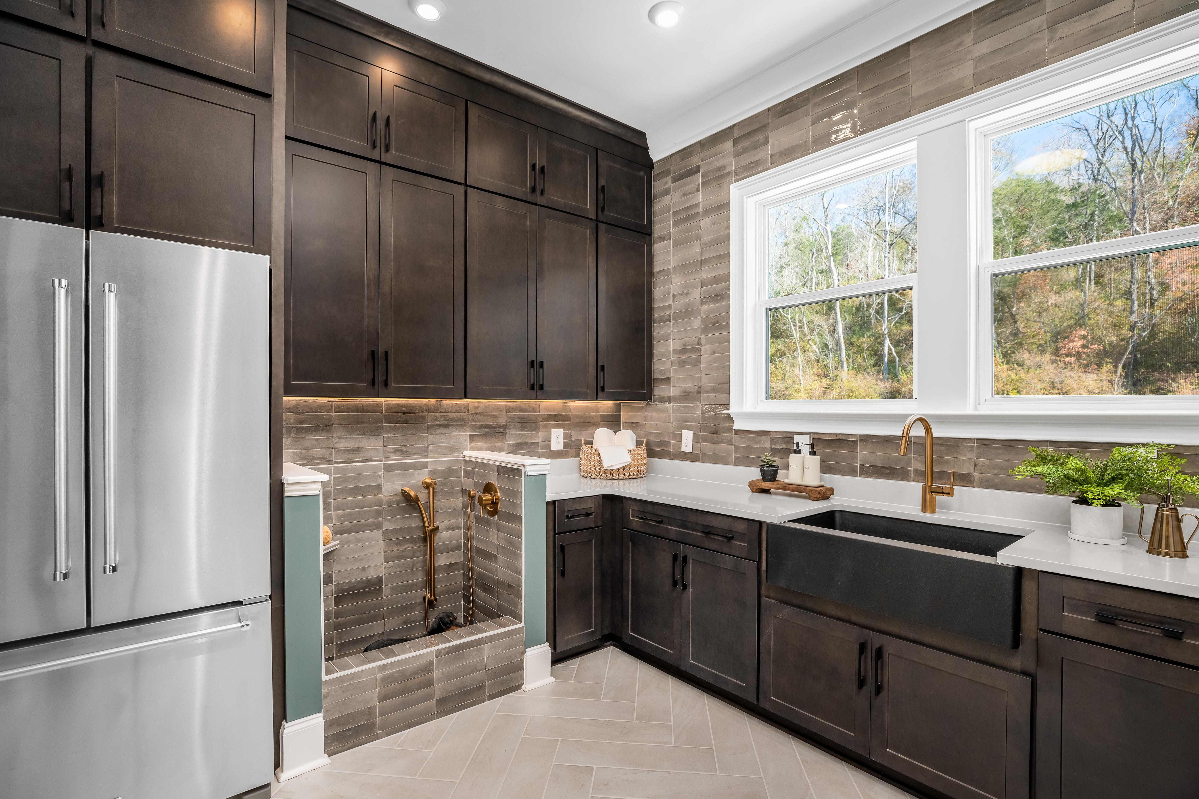 laundry room with dog wash and refridgerator