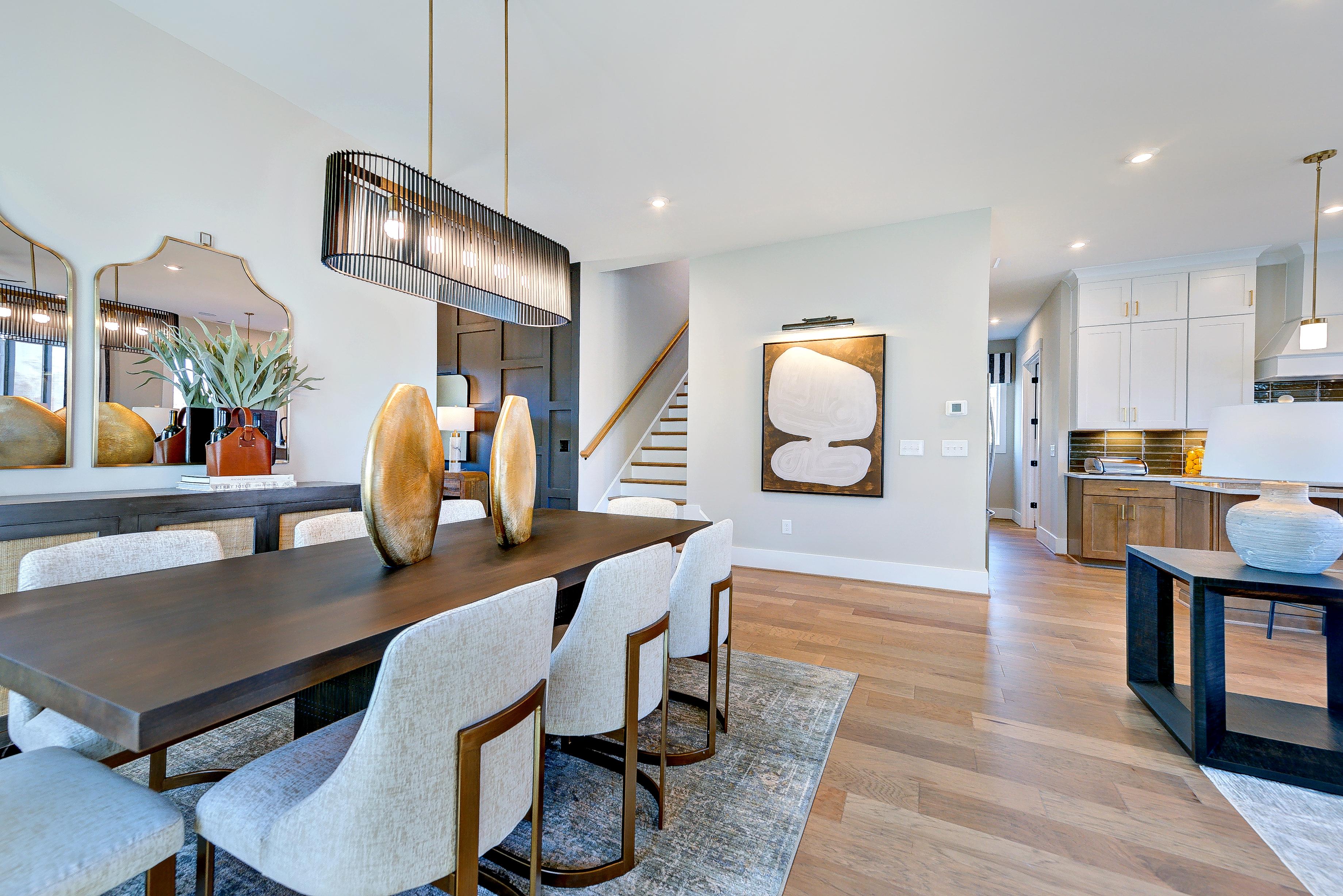 wood floors, table and eight chairs with a stunning centralized light fixture